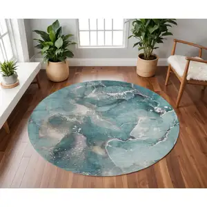 Photo of 8' Teal And Ivory Abstract Washable Round Rug With UV Protection