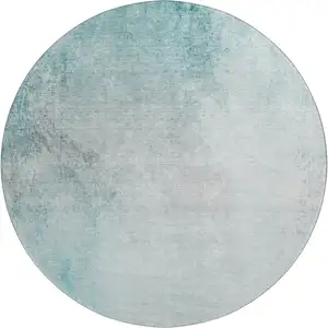 Photo of 8' Teal And Ivory Abstract Washable Round Rug With UV Protection