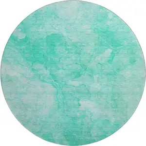 Photo of 8' Teal And Ivory Abstract Washable Round Rug With UV Protection