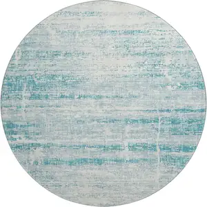 Photo of 8' Teal And Ivory Abstract Washable Round Rug With UV Protection
