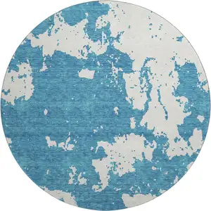 Photo of 8' Teal And Ivory Abstract Washable Round Rug With UV Protection