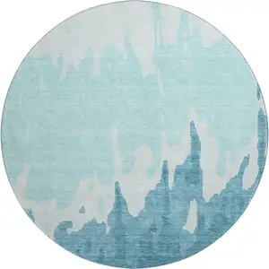 Photo of 8' Teal And Ivory Abstract Washable Round Rug With UV Protection