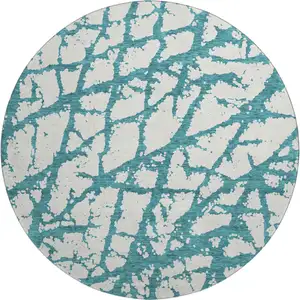 Photo of 8' Teal And Ivory Abstract Washable Round Rug With UV Protection