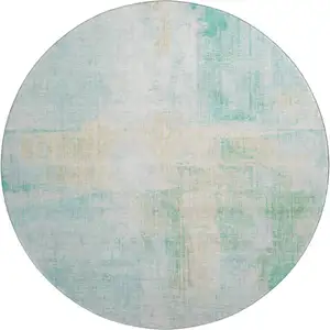 Photo of 8' Teal And Ivory Abstract Washable Round Rug With UV Protection
