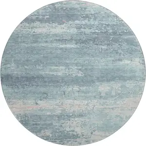Photo of 8' Teal And Ivory Abstract Washable Round Rug With UV Protection