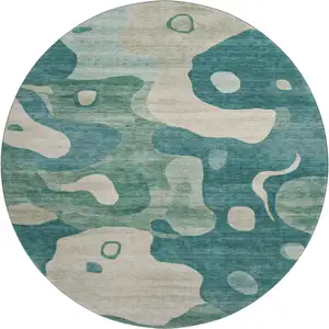 Photo of 8' Teal And Ivory Abstract Washable Round Rug With UV Protection