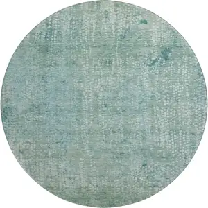 Photo of 8' Teal And Ivory Abstract Washable Round Rug With UV Protection