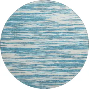 Photo of 8' Teal And Ivory Striped Washable Round Rug With UV Protection