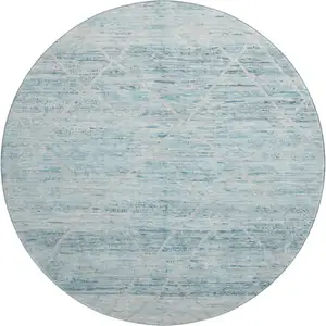 Photo of 8' Teal Beige And Ivory Abstract Geometric Washable Round Rug With UV Protection