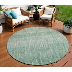 Photo of 8' Teal Blue And Beige Round Abstract Washable Indoor Outdoor Area Rug