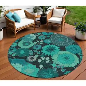 Photo of 8' Teal Blue And Black Round Floral Washable Indoor Outdoor Area Rug