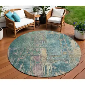 Photo of 8' Teal Blue And Gold Round Abstract Washable Indoor Outdoor Area Rug