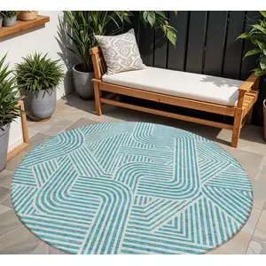 Photo of 8' Teal Blue And Ivory Round Abstract Washable Indoor Outdoor Area Rug