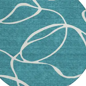 Photo of 8' Teal Blue And Ivory Round Abstract Washable Indoor Outdoor Area Rug