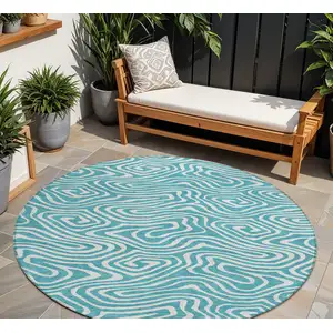 Photo of 8' Teal Blue And Ivory Round Abstract Washable Indoor Outdoor Area Rug