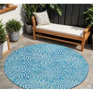 Photo of 8' Teal Blue And Ivory Round Abstract Washable Indoor Outdoor Area Rug