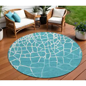 Photo of 8' Teal Blue And Ivory Round Abstract Washable Indoor Outdoor Area Rug
