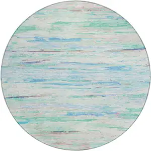 Photo of 8' Teal Blue And Ivory Round Abstract Washable Indoor Outdoor Area Rug