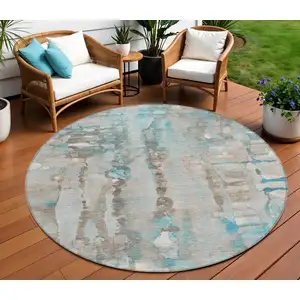 Photo of 8' Teal Blue And Ivory Round Abstract Washable Indoor Outdoor Area Rug