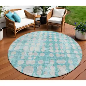 Photo of 8' Teal Blue And Ivory Round Abstract Washable Indoor Outdoor Area Rug
