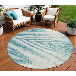 Photo of 8' Teal Blue And Ivory Round Abstract Washable Indoor Outdoor Area Rug