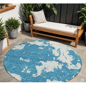 Photo of 8' Teal Blue And Ivory Round Abstract Washable Indoor Outdoor Area Rug