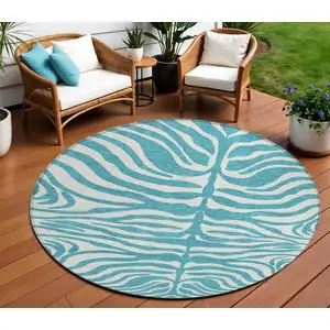 Photo of 8' Teal Blue And Ivory Round Animal Print Washable Indoor Outdoor Area Rug