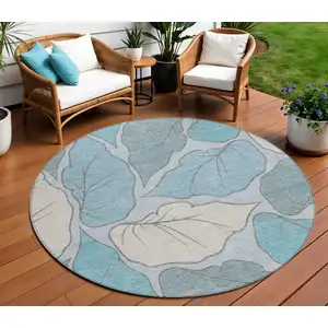 Photo of 8' Teal Blue And Ivory Round Botanical Leaves Washable Indoor Outdoor Area Rug