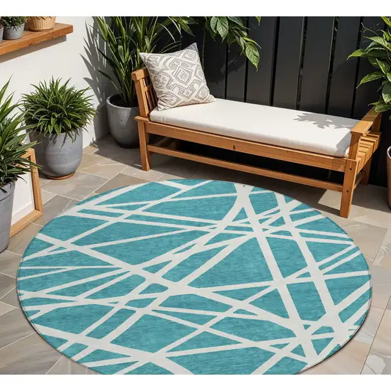 8' Teal Blue And Ivory Round Geometric Washable Indoor Outdoor Area Rug Photo 1
