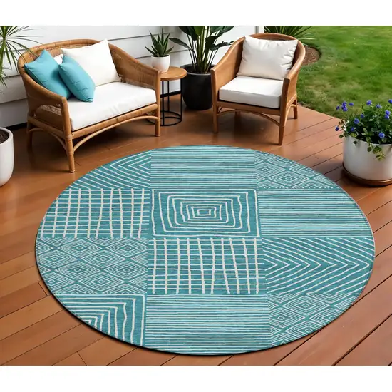 8' Teal Blue And Ivory Round Geometric Washable Indoor Outdoor Area Rug Photo 1