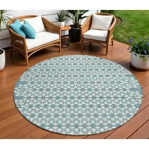 Photo of 8' Teal Blue And Ivory Round Geometric Washable Indoor Outdoor Area Rug