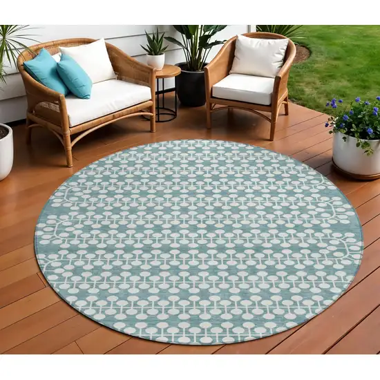 8' Teal Blue And Ivory Round Geometric Washable Indoor Outdoor Area Rug Photo 1