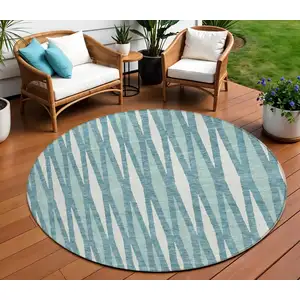 Photo of 8' Teal Blue And Ivory Round Geometric Washable Indoor Outdoor Area Rug