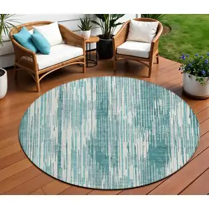 Photo of 8' Teal Blue And Ivory Round Striped Washable Indoor Outdoor Area Rug