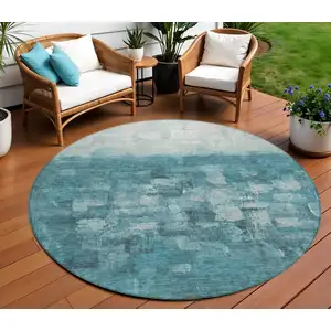 Photo of 8' Teal Blue And Silver Round Abstract Washable Indoor Outdoor Area Rug