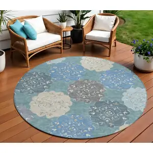 Photo of 8' Teal Blue Beige And Ivory Round Quatrefoil Washable Indoor Outdoor Area Rug