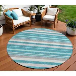 Photo of 8' Teal Blue Gray And Ivory Round Striped Washable Indoor Outdoor Area Rug