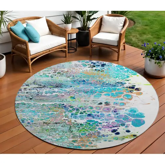 8' Teal Blue Ivory And Gold Round Abstract Washable Indoor Outdoor Area Rug Photo 1