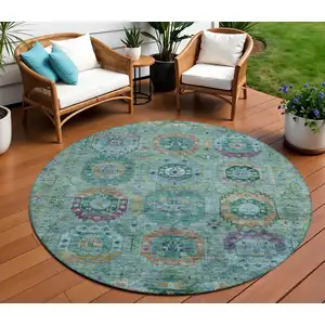 Photo of 8' Teal Blue Purple And Gold Round Medallion Washable Indoor Outdoor Area Rug