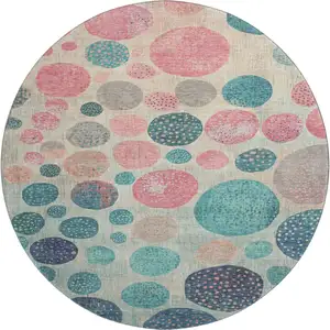 Photo of 8' Teal Pink And Beige Geometric Washable Round Rug With UV Protection