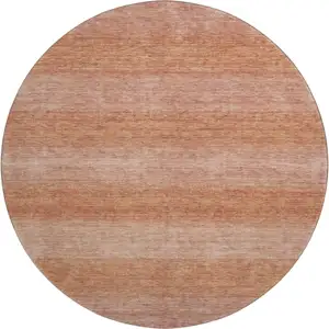 Photo of 8' Terra Cotta And Peach Striped Washable Round Rug With UV Protection