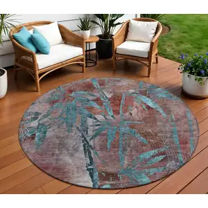 Photo of 8' Terra Cotta And Teal Blue Round Botanical Leaves Washable Indoor Outdoor Area Rug