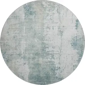 Photo of 8' Turquoise And Ivory Abstract Washable Round Rug With UV Protection