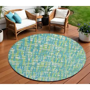 Photo of 8' Turquoise Green And Ivory Round Abstract Washable Indoor Outdoor Area Rug