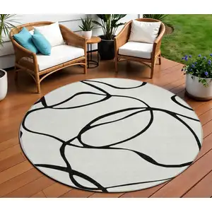Photo of 8' White And Black Round Abstract Washable Indoor Outdoor Area Rug