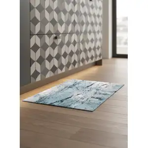 Photo of 5' White And Blue Abstract Washable Round Rug With UV Protection