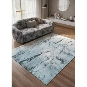 Photo of 8' White And Blue Abstract Washable Round Rug With UV Protection