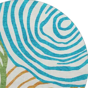 Photo of 8' White Blue And Green Abstract Washable Round Rug With UV Protection