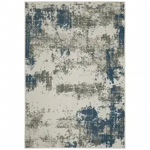 Photo of 6' X 9' Beige Abstract Stain Resistant Indoor Outdoor Area Rug
