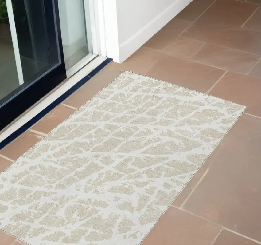 3' X 4' Beige and Ivory Abstract Washable Non Skid Indoor Outdoor Area Rug Photo 1